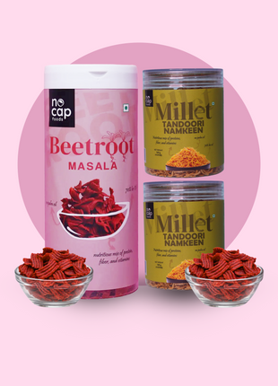 Two containers of beetroot masala and millet tandoori namkeen on a pink background