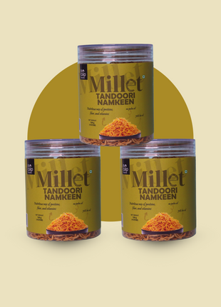 Three jars of Millet Tandoori Namkeen on a beige background